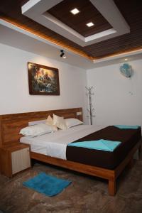 a bedroom with a large bed in a room at Bhuvanam homestay in Kalpetta