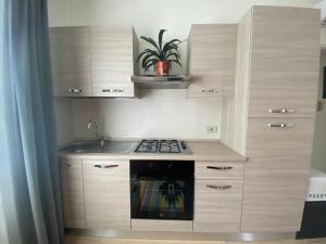 a kitchen with a stove and a sink at Appartamento Miramare in Rimini