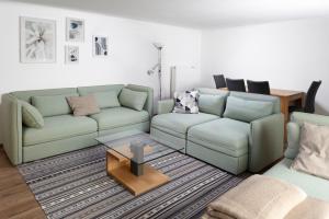 a living room with a couch and a table at Stylish apartment under the Tatras in Štrba