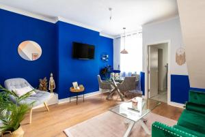 a living room with a blue accent wall at Stylish Retreat In Liverpool's Heart in Liverpool