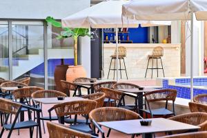 a row of tables and chairs in a restaurant at Maltepe Luxury Accommodation by Travel Pro Services in Kallithea Halkidikis