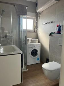 a bathroom with a washing machine and a washer at Apartment Nelli in Medulin