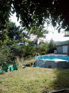 a swimming pool in a yard next to a house at le Chausse à Brès chambre d'hôtes 1 in Payzac