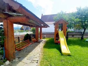 a playground with a slide in the grass at POKOJE GOŚCINNE U ZOŚKI in Murzasichle