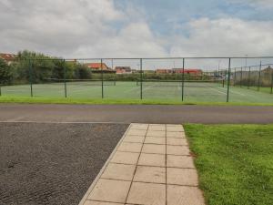 a tennis court with two tennis courts at Turning Tide in Chathill