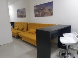 a living room with a couch and a table at Lev Apartments - Apto Beira-Mar - Posto 2 - Copacabana in Rio de Janeiro