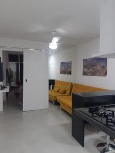 a living room with a couch and a table at Lev Apartments - Apto Beira-Mar - Posto 2 - Copacabana in Rio de Janeiro