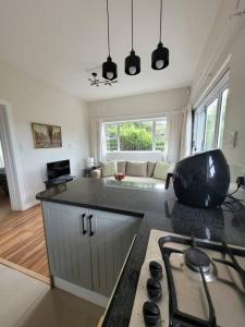 a kitchen with a stove and a living room at Downstairs @38 in Port Elizabeth
