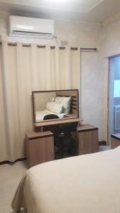 a bedroom with a bed with a mirror and a window at Broadhurst Homestay in Gaborone