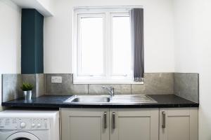 a kitchen with a sink and a window at Rare private room near Centre in Liverpool