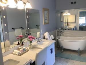 a bathroom with a tub and a sink and a tub and a bath tub at Diana House in Charlottetown +62 photos
