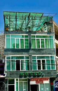 a building with a balcony on top of it at CITRUS Guest House in Yerevan