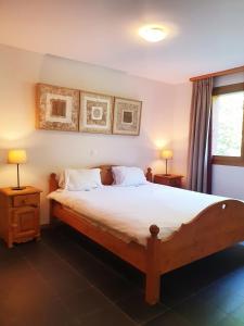 a bedroom with a large wooden bed with two night stands at Alpine Retreat Val D'Illiez in Val-d'Illiez