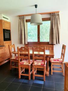 a dining room with a table and chairs and a window at Alpine Retreat Val D'Illiez in Val-d'Illiez