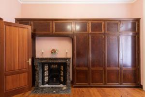 a large wooden closet with a fireplace in a room at Jauregi - baskeyrentals in Lekeitio
