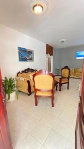 a bedroom with a bed and a chair and a table at Tú rincón placentero in Cabrera