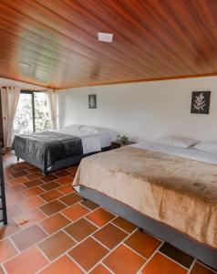 a bedroom with two beds and a wooden ceiling at Prana in Isnos