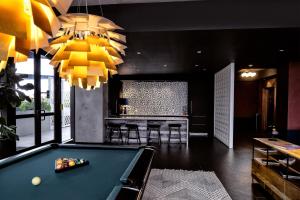 a pool table in a room with a bar at Sentral Wynwood in Miami