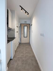 a hallway of a house with white walls and a door at Irisapart A65 in Warsaw