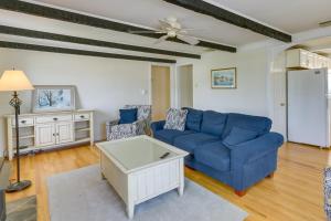a living room with a blue couch and a table at Cozy Westbrook Vacation Rental - Walk to Beach! in Westbrook