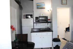 a kitchen with a white refrigerator and a microwave at Master King Suite by Hard rock stadium and casino in Miami