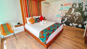 a bedroom with a bed and a poster of the killers at In Di House of Reggae Boutique in San Andrés