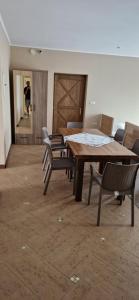 a dining room with a wooden table and chairs at Tulipan Hotel Aquapark in Vyshkove