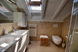a bathroom with a sink and a toilet at Villa Betty in San Siro +29 photos