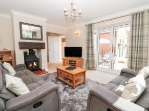 a living room with a couch and a tv and a fireplace at Church View in Hull