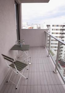 a balcony with two chairs and a table on it at Vitan Central Oasis - NEW Building - FREE Secured Private PARKING - Self Check-in - in Bucharest