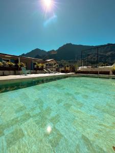 a large swimming pool with blue water at VILLA GRONDIN in Cilaos