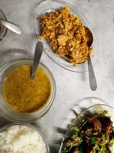 a table with two bowls of food and a plate of rice at VILLA GRONDIN in Cilaos