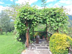 a garden with an arbor with a stone path at Goizeder etxea in Sumbilla