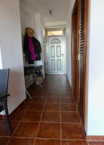 a hallway with a door and a tiled floor at Seaview Cabezo flat fully equipped with parking in El Médano