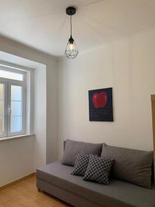 a living room with a couch and a window at Cozy family apartment in Cascais in Cascais