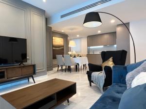 a living room with a blue couch and a table at EATON Residences by WSD in Kuala Lumpur