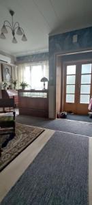 uma grande sala de estar com uma porta e um tapete em Kortteer sininen huoneisto em Rauma