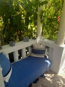 a bench sitting on a porch with plants at Au fil de l eau in Cannes