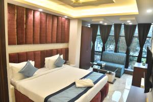 a bedroom with a bed and a chair in a room at City Square in Deoghar