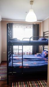 two bunk beds in a room with a window at Tulipan Hotel Aquapark in Vyshkove