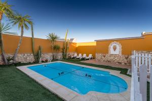 a swimming pool in the backyard of a house at Casa Ludima in Fuentes de Andalucía