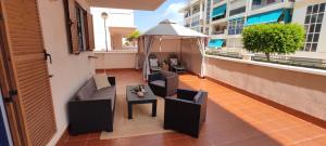 a balcony with two chairs and a table on a building at Heydays Apartment in La Mata +22 photos