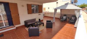 a living room with a couch and a gazebo at Heydays Apartment in La Mata