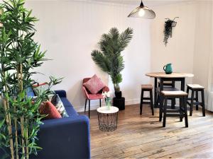 - un salon avec un canapé et une table ornée de plantes dans l'établissement L'Oasis - Charmant appartement Métro Porte d'Italie, au Kremlin-Bicêtre