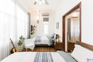 a bedroom with two beds and a mirror at An Family Homestay in Hanoi