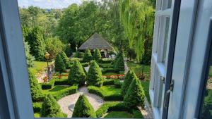 a view of a garden from a window at Dwór Anna in Ciecierzyn