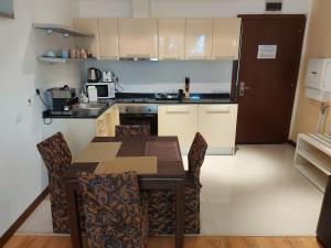 - une cuisine avec une table et des chaises dans la chambre dans l'établissement Apartment D6 in TERRA Spa end Ski Complex, à Bansko