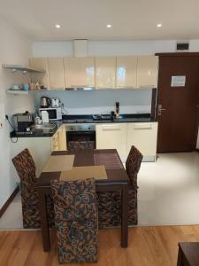a kitchen with a table and chairs in a room at Apartment D6 in TERRA Spa end Ski Complex in Bansko