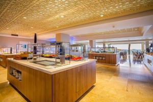 a large kitchen with a counter in a building at Hotel Torre del Mar - Ibiza in Playa d'en Bossa