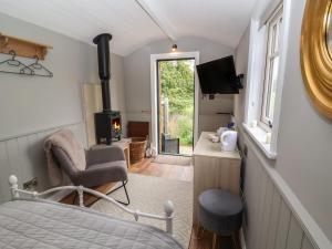 a room with a bed and a chair and a fireplace at Whitehedge in York